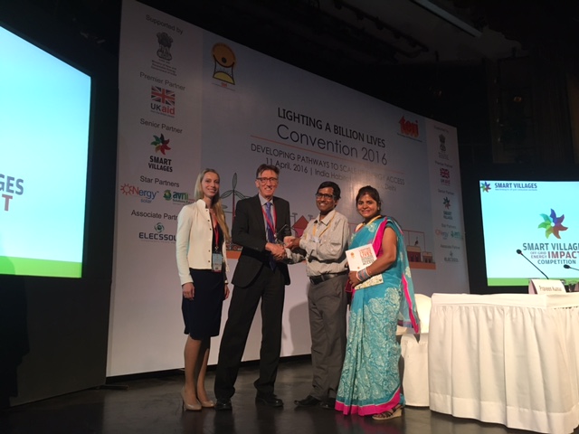 Kristin Polman and John Holmes awarding the Smart Villages Off-grid Energy Impact award to Shyam Patra and Rachita Patra of Naturetech Infra at the Lighting a Billion Lives convention