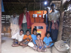 Indian villagers show off a solar microgrid system built and installed by ONergy.