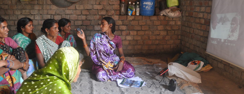 A Community Resource Person (CRP) in Bihar, India, disseminating a video to women's self help groups